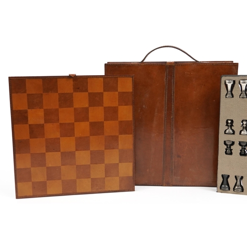 1448 - Tan leather cased travelling chess set with cast metal pieces, the largest piece 8cm high