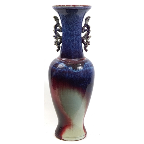 121 - Chinese floor standing vase with twin handles having a flambe glaze, 120cm high