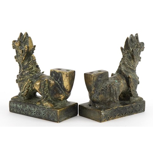 64 - Pair of Chinese patinated bronze guardian dogs, 9.4cm in length