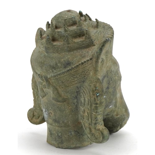 26 - Chino Tibetan patinated bronze head of a mythical animal, 16.5cm high