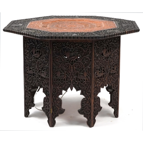 862 - Anglo Indian octagonal oak lamp table profusely carved with birds and fish amongst foliage, 60cm H x... 