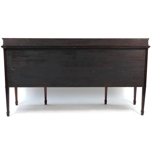 852 - Inlaid mahogany serpentine front sideboard with tambour doors, cupboard doors and drawers raised on ... 