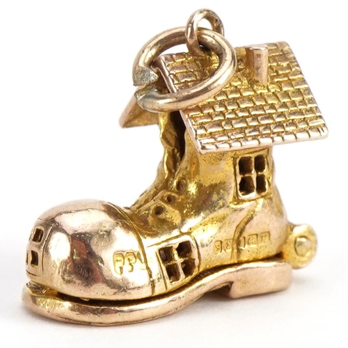 2100 - 9ct gold shoe charm opening to reveal enamelled figures, 1.5cm high, 3.8g