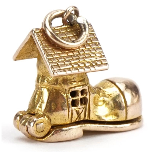 2100 - 9ct gold shoe charm opening to reveal enamelled figures, 1.5cm high, 3.8g