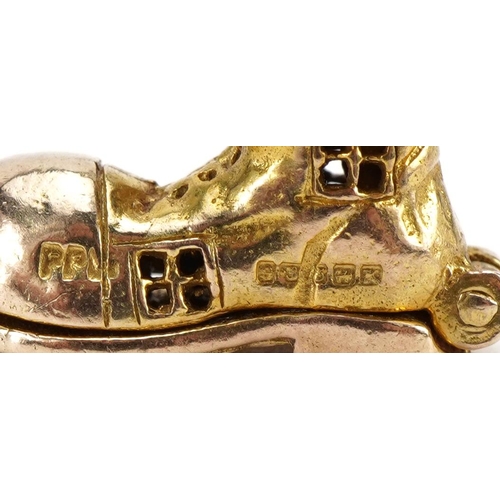 2100 - 9ct gold shoe charm opening to reveal enamelled figures, 1.5cm high, 3.8g