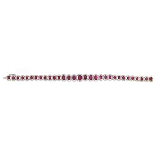 2086 - Impressive 18ct white gold graduated ruby and diamond halo bracelet, total ruby weight approximately... 