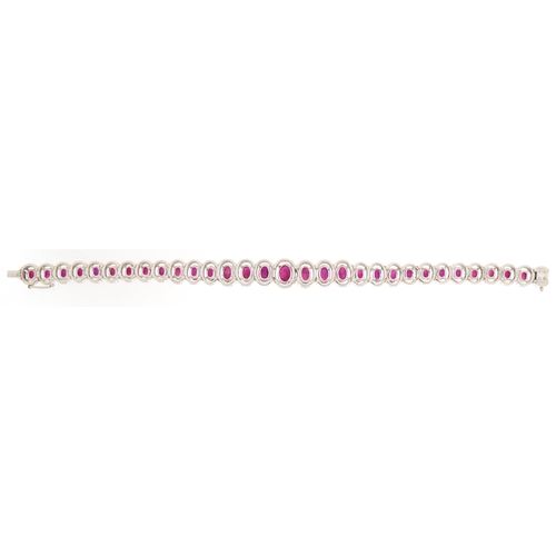 2086 - Impressive 18ct white gold graduated ruby and diamond halo bracelet, total ruby weight approximately... 