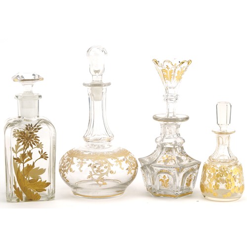 108 - Four 19th century French glass decanters with gilt decoration, the largest 17.5cm high