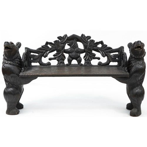 676 - Swiss Black Forest carved bear bench with two standing bears holding a carved backrest decorated wit...