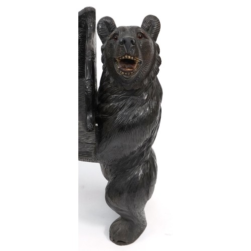 676 - Swiss Black Forest carved bear bench with two standing bears holding a carved backrest decorated wit... 