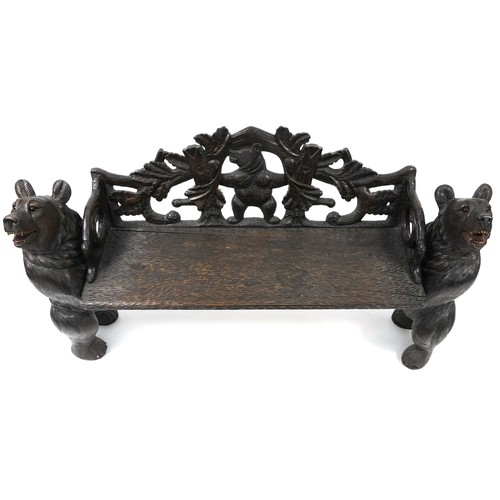 676 - Swiss Black Forest carved bear bench with two standing bears holding a carved backrest decorated wit... 