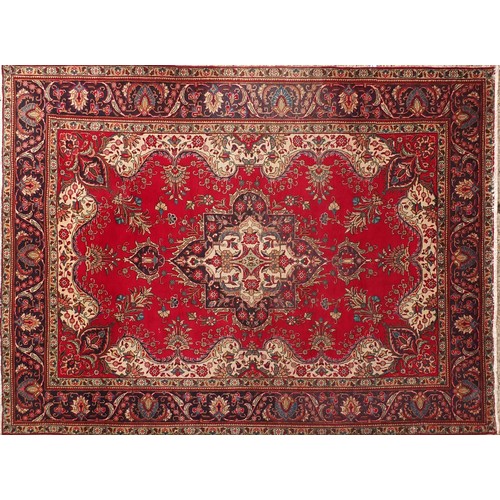 679 - Hand made Iranian carpet with stylised floral pattern onto a red and blue ground, 354cm x 254cm