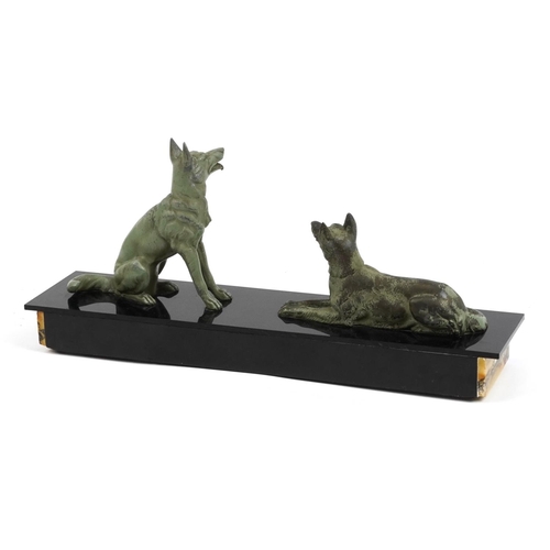 34 - Art Deco black slate and marble centrepiece surmounted with two patinated spelter dogs, 42cm in leng... 