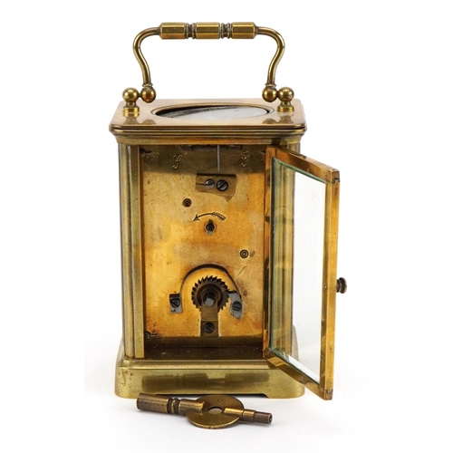 113 - French brass cased carriage clock with enamelled chapter ring having Roman numerals, 11cm high