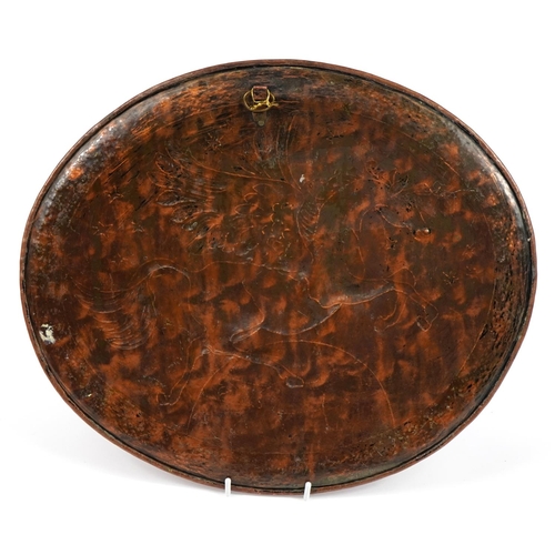 299 - Manner of Newlyn, Arts & Crafts copper oval charger embossed with Pegasus, 43cm wide