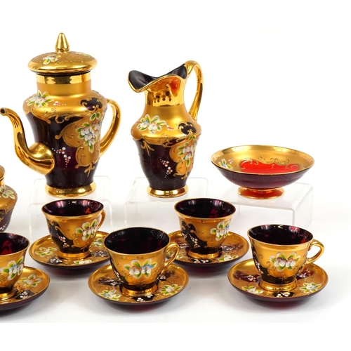 118 - Murano six place partially gilt ruby glass tea service hand painted with flowers, the largest 20.5cm... 