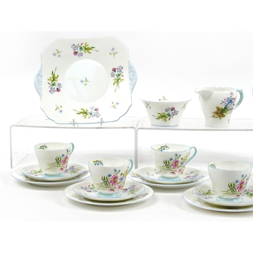 1089 - Shelley Wild Flowers teaware comprising six trios, milk jug, sugar bowl and cake plate, the largest ... 