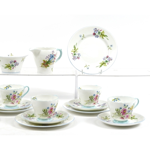 1089 - Shelley Wild Flowers teaware comprising six trios, milk jug, sugar bowl and cake plate, the largest ... 