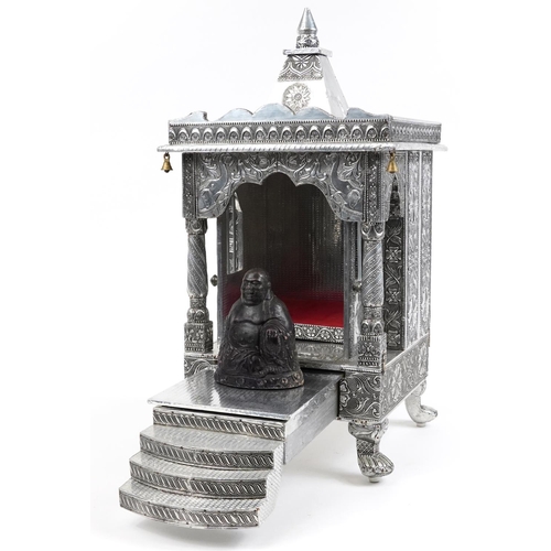 1105 - Large silvered table top Indian shrine housing a stoneware figure of Buddha, 71cm high