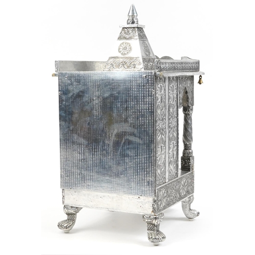 1105 - Large silvered table top Indian shrine housing a stoneware figure of Buddha, 71cm high