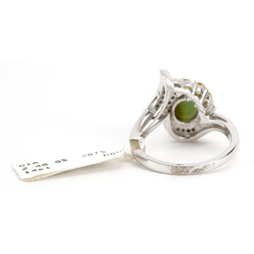 2047 - 14ct white gold green stone, yellow sapphire and diamond crossover ring, the largest green stone app... 