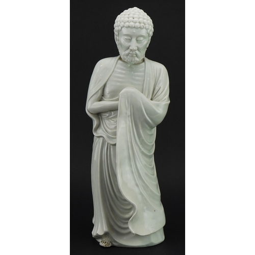 51 - Large Chinese porcelain figure of a Buddhist god having a blanc de chine glaze, 43.5cm high