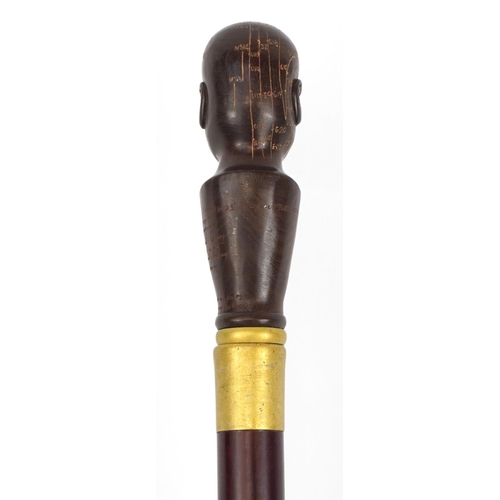 1111 - Hardwood walking stick with carved wood phrenology head handle, 93cm in length