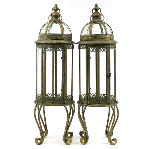 1113 - Pair of partially gilt and glazed lantern design candleholders, 82cm high