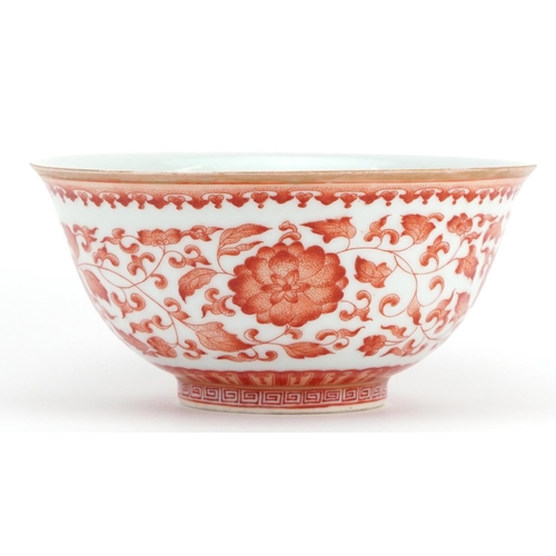 183 - Chinese iron red porcelain bowl hand painted with flower heads amongst scrolling foliage, six figure... 