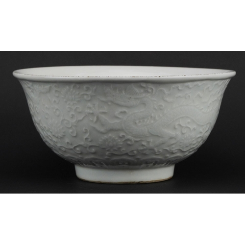 329 - Large Chinese porcelain footed bowl having a blanc de chine glaze decorated in low relief with drago... 