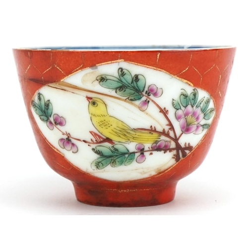 327 - Chinese porcelain iron red ground tea bowl hand painted in the famille rose palette with birds among... 