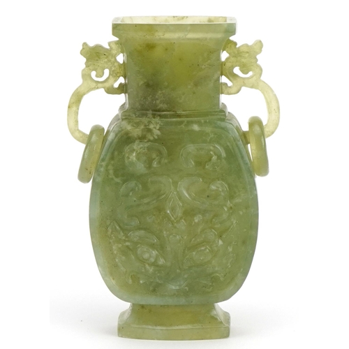 209 - Chinese green hardstone vase with twin ring turned handles carved with archaic style faces, 11cm hig... 