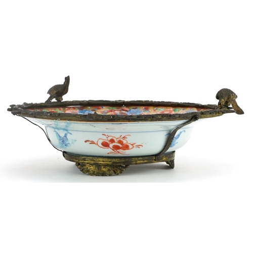 368 - Chinese porcelain soup bowl with gilt metal mounts hand painted with flowers, 25cm in diameter