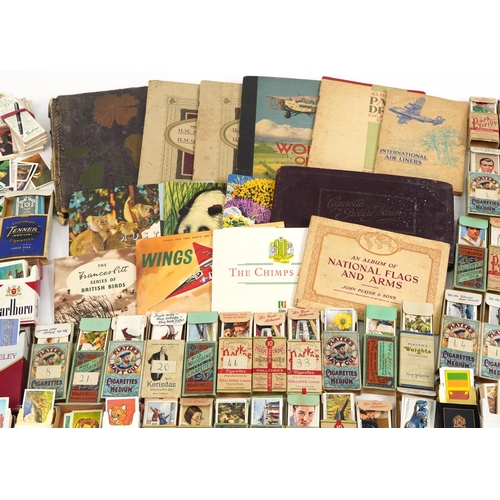 595 - Extensive collection of cigarette and tea cards, some arranged in albums including Brooke Bond Tea, ... 