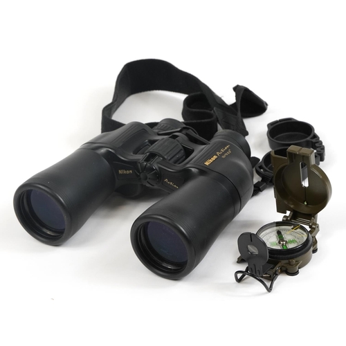 414 - Pair of Nikon Action BJ556671 binoculars with case and a pocket compass