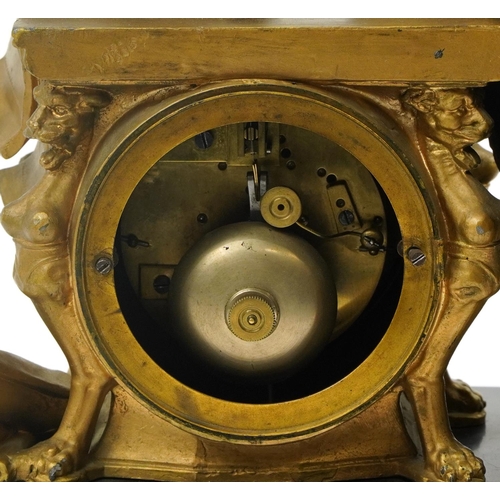 110 - French gilt metal and black slate mantle clock striking on a bell and mounted with a female reading,... 