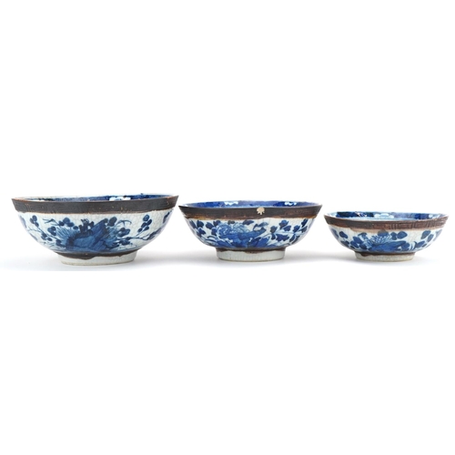 93 - Graduated set of three Chinese crackle glazed bowls hand painted with flowers and landscapes, the la... 