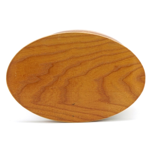 1200 - Wooden sculpture of an American football raised on an oval plinth base, 27cm wide x 24cm high