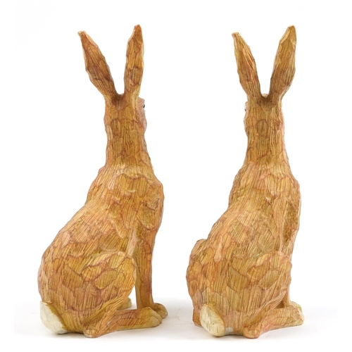 1181 - Pair of painted carved wood seated hares, 34cm high