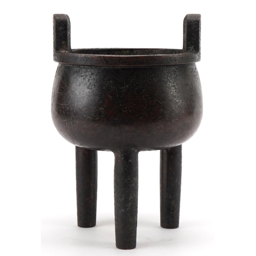 104 - Chinese patinated bronze tripod censer with twin handles and white metal inlay, decorated with birds... 