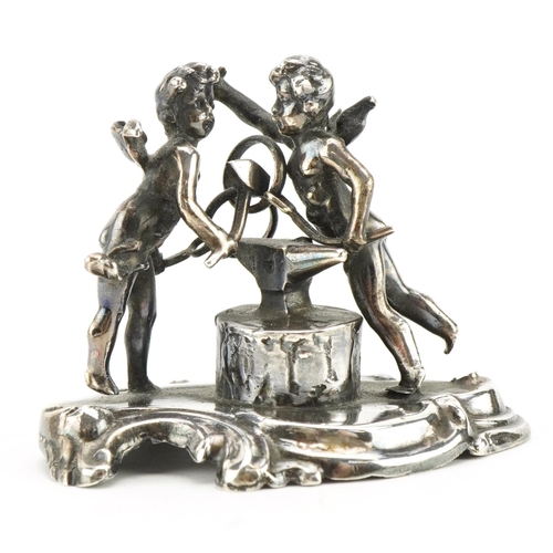 2775 - Victorian silver study of two Putti beside and anvil, Chester 1898, 4.5cm high, 46.3g