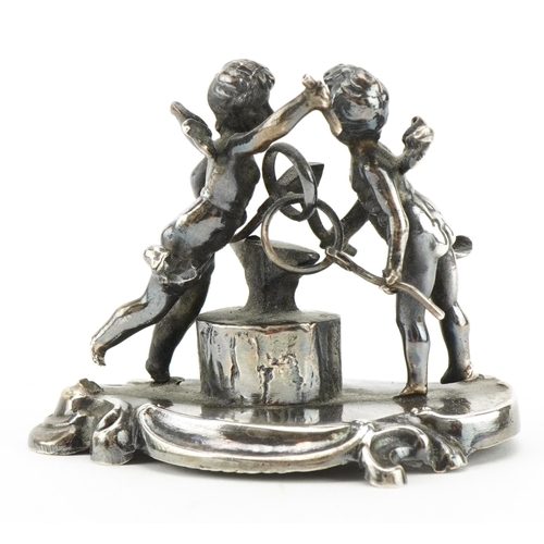 2775 - Victorian silver study of two Putti beside and anvil, Chester 1898, 4.5cm high, 46.3g