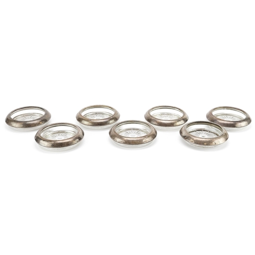 2718 - Frank M Whiting, set of seven circular sterling silver mounted dishes, 10cm in diameter