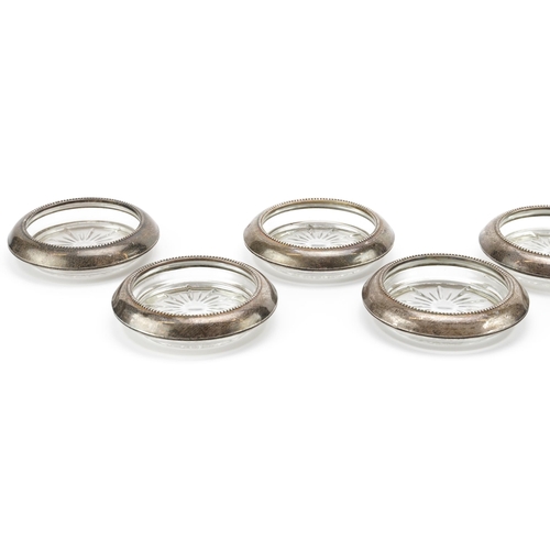 2718 - Frank M Whiting, set of seven circular sterling silver mounted dishes, 10cm in diameter