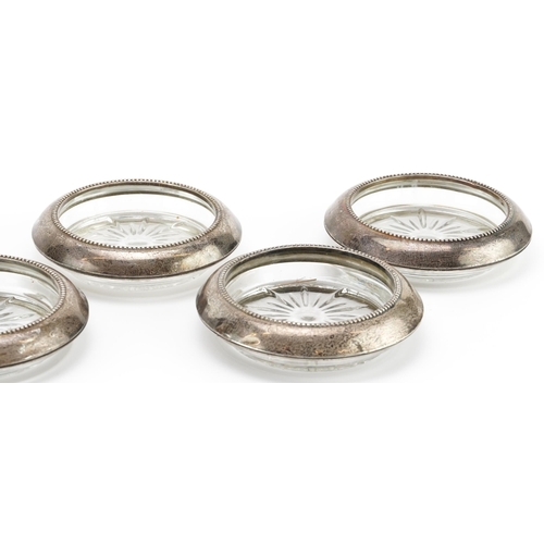 2718 - Frank M Whiting, set of seven circular sterling silver mounted dishes, 10cm in diameter