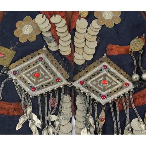 222 - Persian coin set waistcoat with white metal talismans and coins, 59cm high