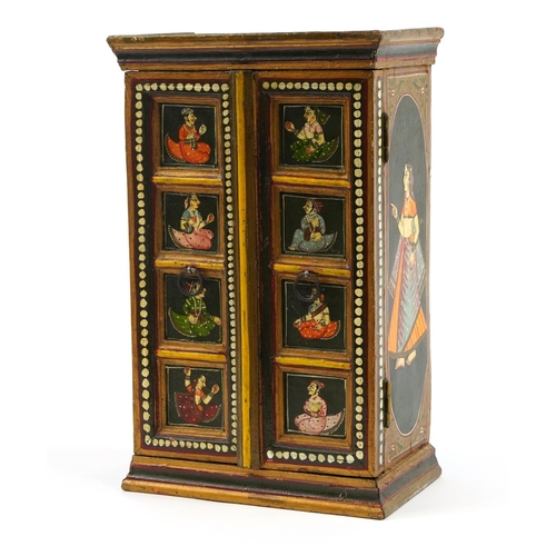 221 - Indian hardwood wall cupboard enclosing three shelves, hand painted with figures in traditional dres... 