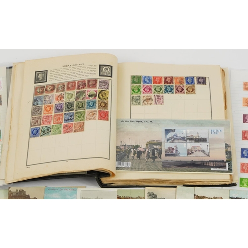 577 - Antique and later ephemera including topographical postcards and stamps arranged in an album