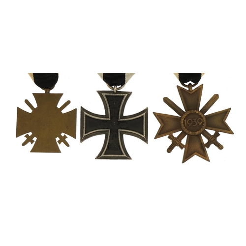 671 - Three German military interest medals comprising Iron Cross, Knights Cross and Honour Cross