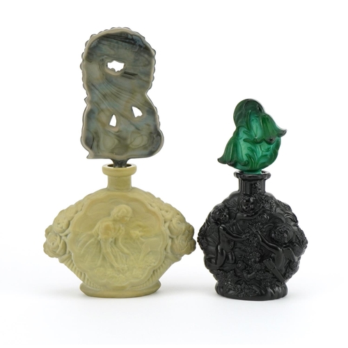 121 - Two Bohemian Art Deco malachite glass scent bottles with stoppers, each moulded with figures, the la... 